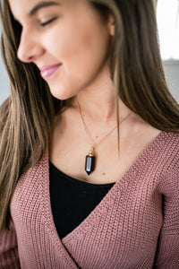 Obsidian essential oil vial necklace on model